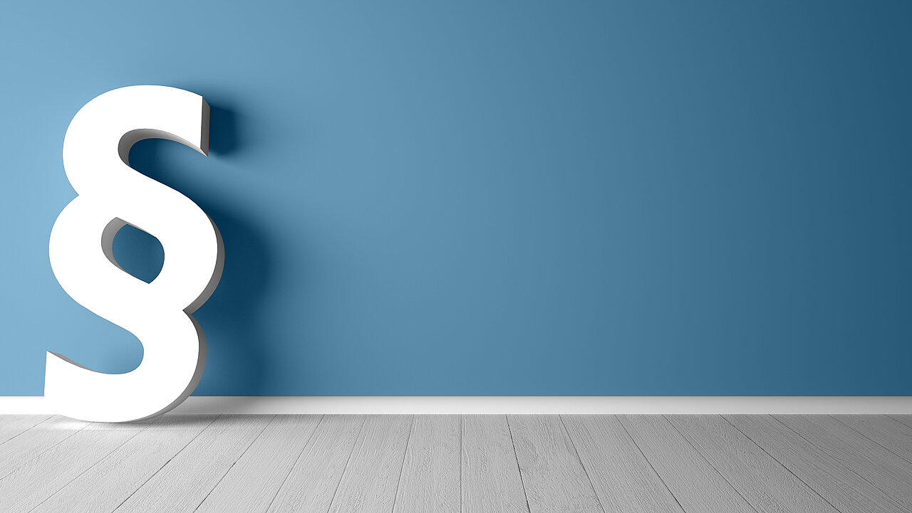 Weißes Paragraphensymbol vor blauem Hintergrund